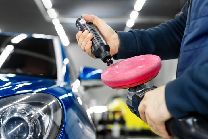 Étudiant en formation en esthétique automobile qui travaille sur le polissage d’un véhicule