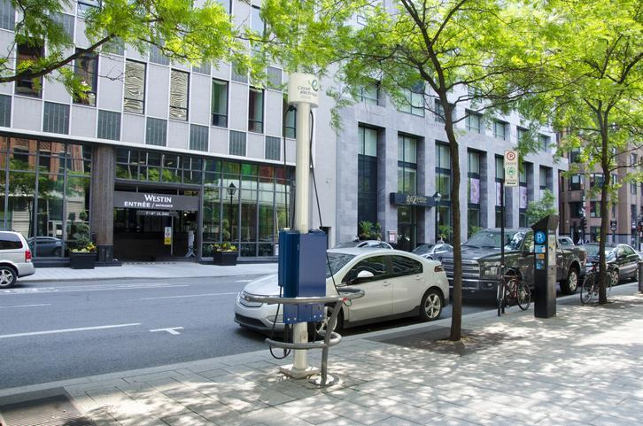 véhicule électrique au centre ville de Montréal stationné à une borne de recharge