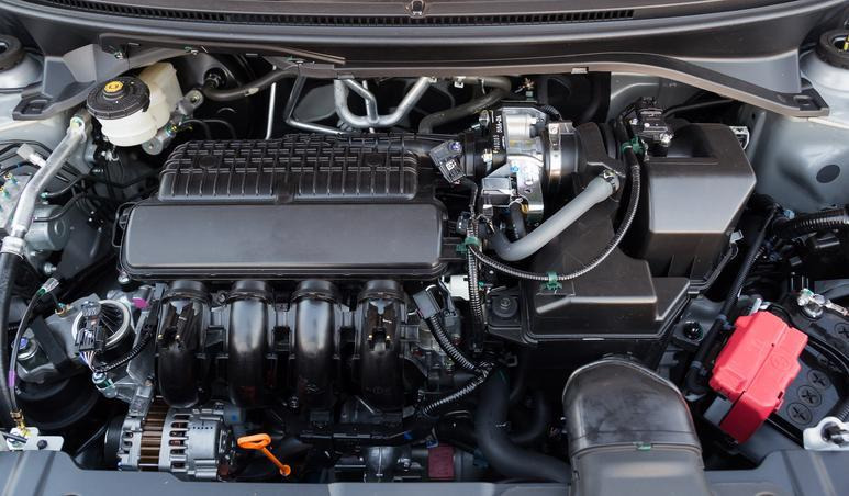 commis aux pièces vérifiant une référence automobile dans un catalogue informatisé